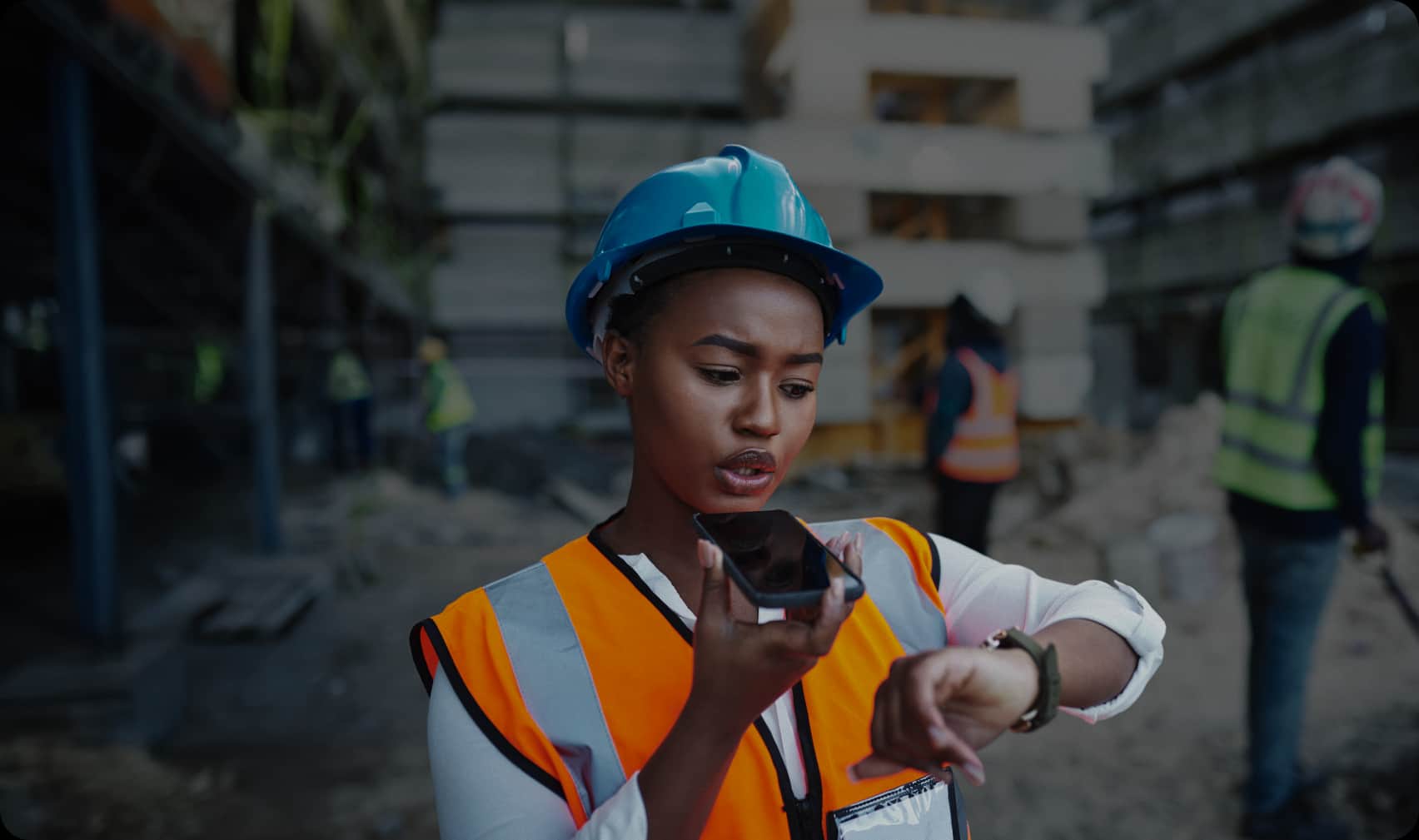 A superintendent takes an Unbane call on a phone at the jobsite